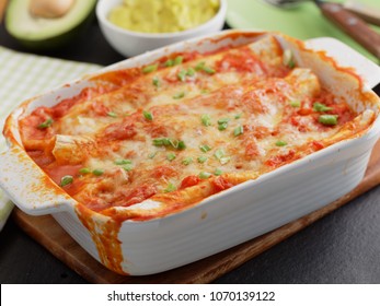 Three Enchiladas In A Baking Dish