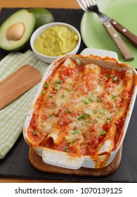 Three Enchiladas In A Baking Dish