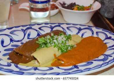 Three Enchiladas On A Plate