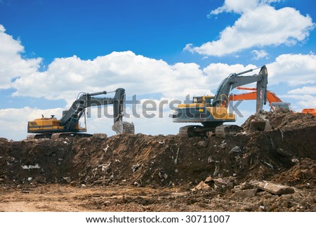 Three excavators working on a constuction site