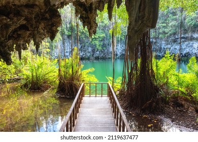 Three eyes cave in Santo Domingo, los Tres Ojos national park, Dominican Republic. Scenic view of limestone cave, beautiful lake and tropical plants, nature landscape, outdoor travel background