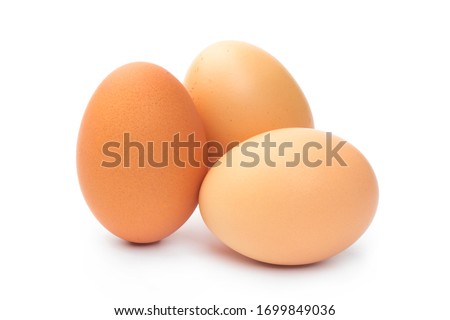 three farm brown chicken eggs on a white background