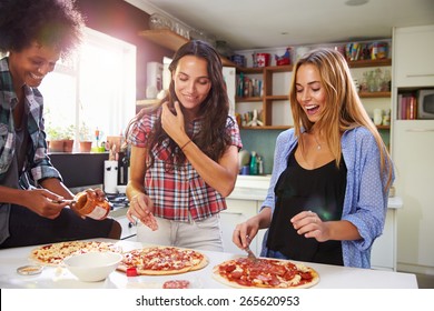 Three Female Friends Making Pizza In Kitchen Together - Powered by Shutterstock