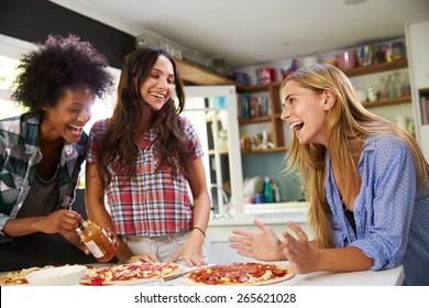 Three Female Friends Making Pizza In Kitchen Together - Powered by Shutterstock