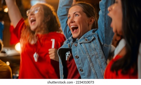 Three Female Friends Watching a Live Soccer Match on TV in a Sports Bar. Happy Girls Cheering and Shouting. Young Fans Celebrating When Team Scores a Goal and Wins the Football World Cup. - Powered by Shutterstock