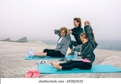 Three Female Generations Exercising By Sea Pier