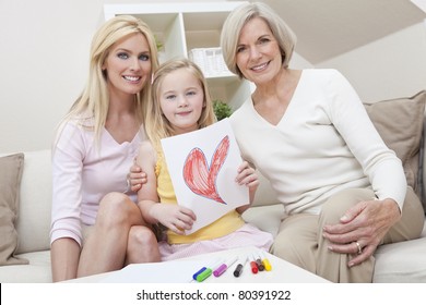 Three female generations one family at home  Mother  grandmother   daughter who is holding hand drawn picture red heart  Love healthy living concept 