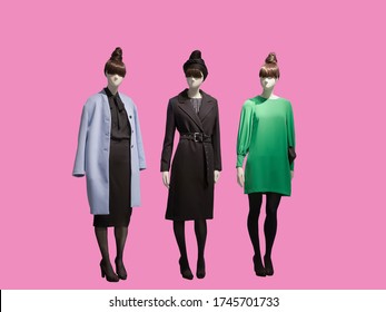 Three female mannequins dressed in fashionable clothes, isolated. No brand names or copyright objects.