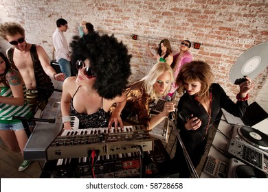 Three Female Performers At A 1970s Disco Music Party