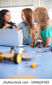 Three Female Students Building And Programing Robot Vehicle In After School Computer Coding Class