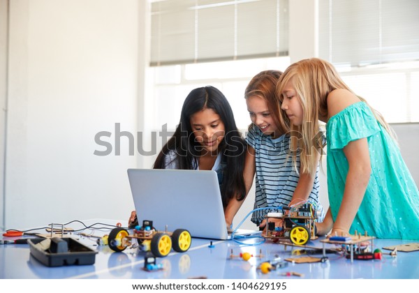 Three Female Students\
Building And Programing Robot Vehicle In After School Computer\
Coding Class