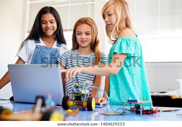 Three Female Students\
Building And Programing Robot Vehicle In After School Computer\
Coding Class