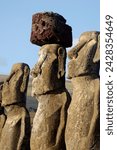 Three of the fifteen huge moai statues standing with their backs to the ocean, restored by archaeologists after destruction in 1960 by a tidal wave, Ahu Tongariki, Easter Island,