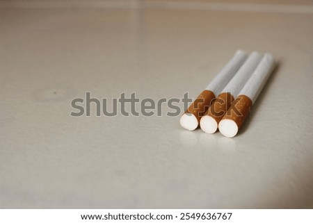 three filter cigarettes on the tiles 