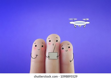 Three fingers decorated as three friends playing with drone.