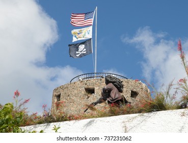 Three flags on a top of 17th century Blackbeard Castle in Charlotte Amalie town on St. Thomas island (U.S. Virgin Islands).