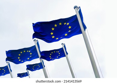 three flags in a row. 3 European flags on a flagpole waving in blue  sky backdrop. European Union. isolated on white background. European Union flag waving on white background. 