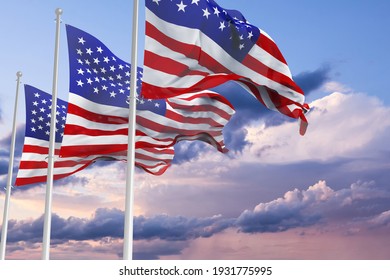 three Flags of United States of America being waved in the breeze against a sunset sky. US flag