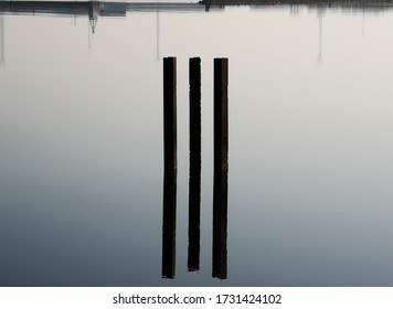 three floating sticks hovering over lake