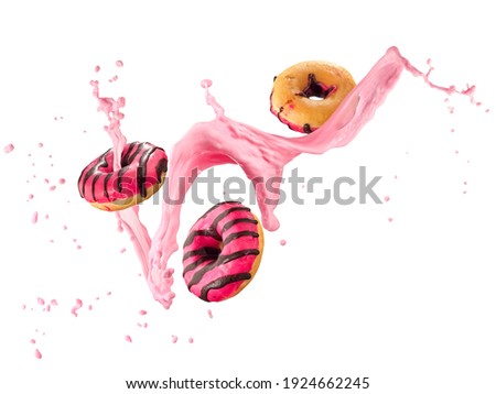 Three flying strawberry donuts with strawberry smoothie splash