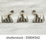 Three forks on the table cloth. Closeup. Shallow DOF.