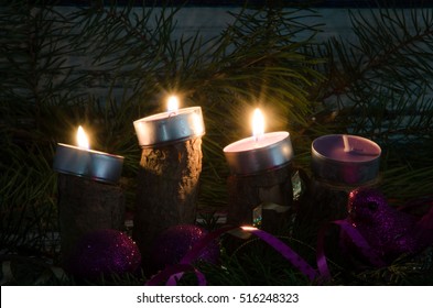 three from four advent candles burning