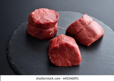 Three Fresh Raw Prime Black Angus Tenderloin Beef Steaks On Stone Background. Selected Focus.