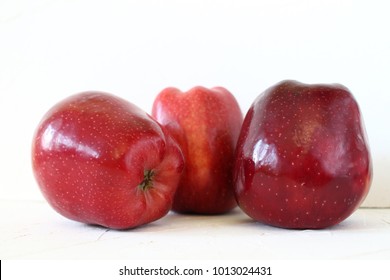 three Fresh red apples on white background