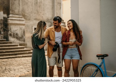 Three friends capturing candid moments and landmarks with genuine excitement - Powered by Shutterstock