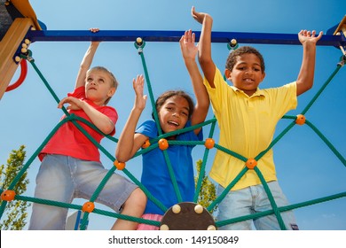 Three friends climbing the net