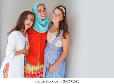 Three Friends Of Different Religions Standing Happily Together