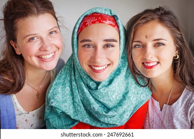 three friends of different religions standing happily together - Shutterstock ID 247692661