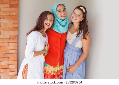 Three Friends Of Different Religions Standing Happily Together