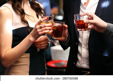 three friends drinking whiskey on  party in club