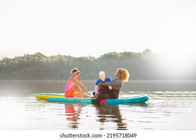 Three Friends Enjoying Their Day And Relaxing On SUP Boards