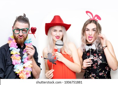 three friends girls pose photo booth shoot party studio wedding drunk props happy camera