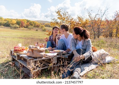 Three friends had a picnic in the fresh air. 3 young women eat food beautifully. Girlfriend concept. Autumn forest.
