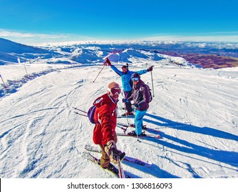 Three friends having fun in Pyrenees, Spain: Ski group of friends taking a fish eye selfie with gopro stick in the mountain top covered in snow after skiing in Spain. Winter sports on holidays, 2019 - Powered by Shutterstock