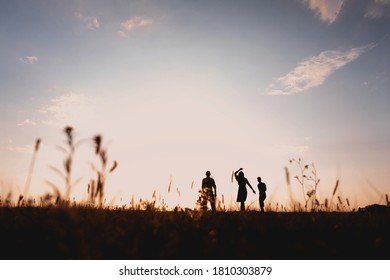 Three Friends Running Across The Field At Night