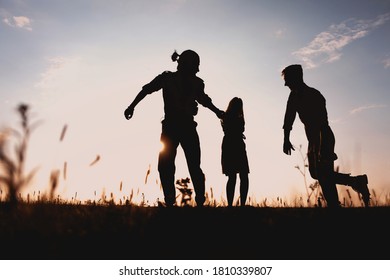 Three Friends Running Across The Field At Night