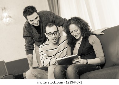 Three Friends with Tablet PC on a Sofa