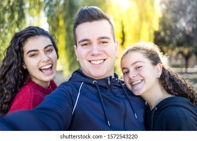 Three friends taking a selfie on a park