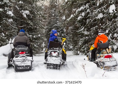 Three Friends Traveling By Snowmobile In The Mountains And Forests Of The Southern Urals.