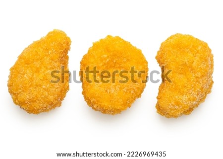 Three frozen gluten free cornflake crumb chicken nuggets isolated on white. Top view.