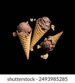 Three frozen ice cream desserts in sugar cones topped with chocolate and served with scattered chopped nuts on a black Background.