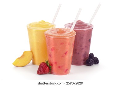 Three Fruit Smoothies or Shakes with Straws and Garnishes on a White Background