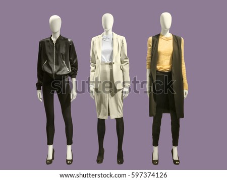 Three full-length female mannequins dressed in fashionable clothes, isolated.  No brand names or copyright objects.
