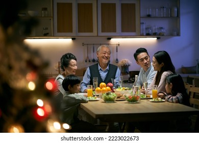 three generation asian family gathering at home having dinner celebrating christmas - Powered by Shutterstock