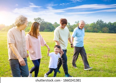 Three Generation Asian Family Walking  In The Park