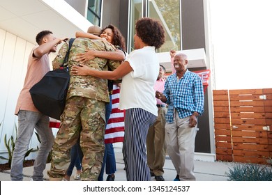 Three generation black family welcoming millennial male soldier returning home,low angle view - Powered by Shutterstock